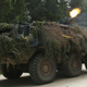 An Estonian armored personnel carrier fires blanks from a machine gun during a 2015 exercise.